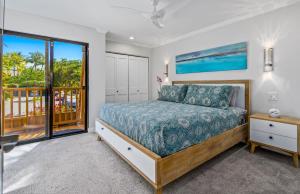 a bedroom with a bed and a balcony at Luxurious & Spacious Ocean Vistas in Wailea