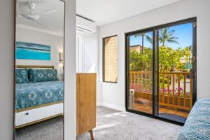 a bedroom with a bed and a balcony at Luxurious & Spacious Ocean Vistas in Wailea