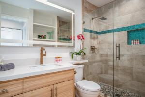 a bathroom with a shower and a toilet and a sink at Luxurious & Spacious Ocean Vistas in Wailea