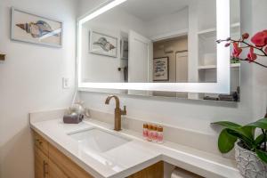 a bathroom with a sink and a mirror at Luxurious & Spacious Ocean Vistas in Wailea