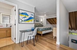 a bedroom with a desk and a bed in a room at Luxurious & Spacious Ocean Vistas in Wailea