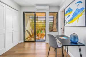 a dining room with a table and two chairs at Luxurious & Spacious Ocean Vistas in Wailea