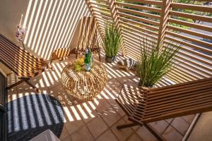 a balcony with two chairs and plants on a patio at Luxurious & Spacious Ocean Vistas in Wailea
