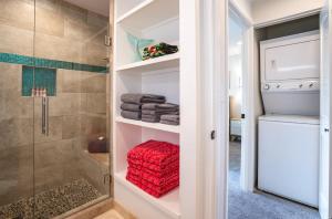 a bathroom with a shower and a red towel at Luxurious & Spacious Ocean Vistas in Wailea