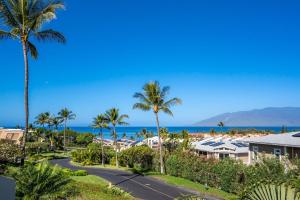 a view of the beach and palm trees at Luxurious & Spacious Ocean Vistas in Wailea