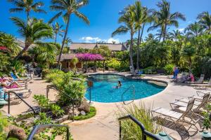 a pool at a resort with people playing in it at Luxurious & Spacious Ocean Vistas in Wailea