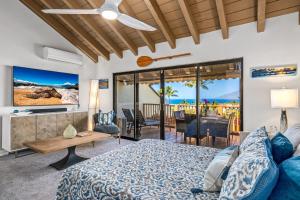 a bedroom with a bed and a view of the ocean at Luxurious & Spacious Ocean Vistas in Wailea
