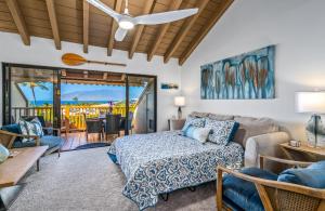 a living room with a bed and a couch at Luxurious & Spacious Ocean Vistas in Wailea