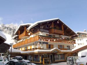 a large building with snow on the roof at Charmant 2 pièces au cœur des Gets, proche télécabines, balcon, Wi-Fi, garage, animaux bienvenus - FR-1-671-137 in Les Gets