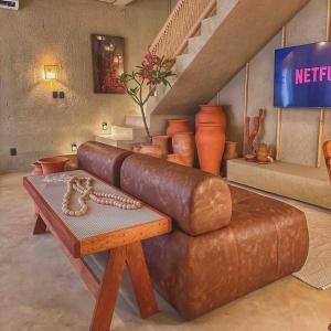 Camera con divano, tavolo e scale di Villa Aconchego - Casas de Luxo a São Miguel dos Milagres