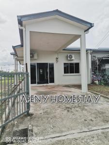 a small house with a warranty sign in front of it at Afeny Homestay in Tawau