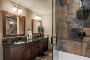 a bathroom with a sink and a shower at Spring Creek Vacations in Canmore +260 photos