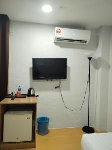 a room with a flat screen tv on a wall at Maple Boutique Hotel Kota Bharu in Kota Bharu