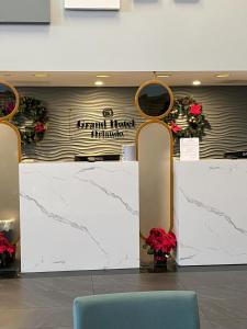 a lobby with a white marble counter and chairs at Grand Hotel Orlando at Universal Blvd in Orlando