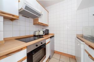 a small kitchen with a sink and a stove at Shiny 1BR Flat in Fitzrovia, 2 min to Tube in London