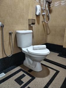 a bathroom with a toilet in a shower stall at Maple Boutique Hotel Kota Bharu in Kota Bharu