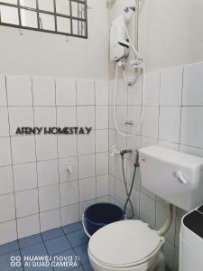 a bathroom with a toilet and a shower at Afeny Homestay in Tawau