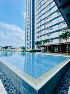 a large swimming pool next to a tall building at 2-Bedroom Condo Unit with Balcony at Centrio Tower beside Ayala Centrio Mall Downtown CDO in Cagayan de Oro