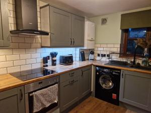 a kitchen with a washer and a dishwasher at Purdie Close Holiday Let in Cheddar