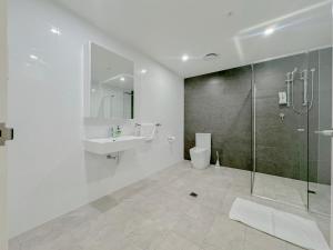 een badkamer met een douche, een toilet en een wastafel bij Burwood Cozy Apartment Free Parking in Sydney
