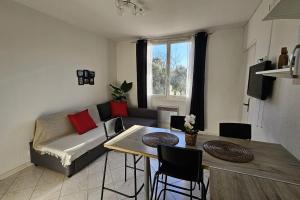 a living room with a couch and a table at Beautiful T2 - close to the sea in La Seyne-sur-Mer