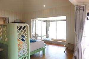a bedroom with a bed and a large window at Koh Mook Sivalai Beach Resort in Ko Mook