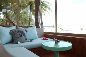 a living room with a couch and a table at Koh Mook Sivalai Beach Resort in Ko Mook