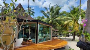 a house on a beach with palm trees at Koh Mook Sivalai Beach Resort in Ko Mook