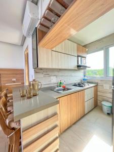 a kitchen with wooden cabinets and a counter top at Caribbean Escape Lodge in San Silvestre