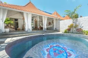 a swimming pool in front of a house at Sanctuary Villas in Ubud