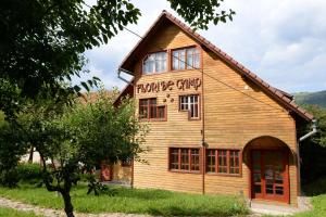 a building with a sign on the side of it at Pensiunea Flori de Camp in Vatra Dornei