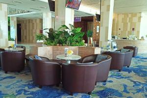 a restaurant with tables and chairs in a lobby at ABHOME "SKY GARDEN SUITE" #DangaBay #Sea & Garden View #BeachBay #BeletimeMall #JB in Johor Bahru