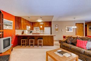 a living room with a couch and a kitchen at Tyra I A2D in Breckenridge