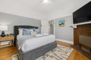 a bedroom with a large bed and a fireplace at Bluestone Cottage - Character & Class in Orange +14 photos