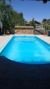 a large blue swimming pool in a yard at Cabañas Sangiovese San Rafael in San Rafael