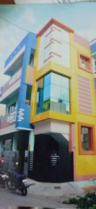 a colorful building with a motorcycle parked in front of it at Siddharth illam in Puducherry