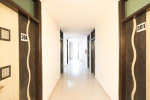 a hallway of an office building with the number on the walls at OYO Flagship 61722 Rajmahal Residency Hotel in Bhiwadi