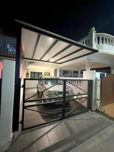 a porch with a gate on a house at night at KonZept House for 14pax #5minwalk Jonker@Heritage in Melaka