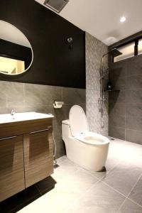 a bathroom with a toilet and a sink and a mirror at KonZept House for 14pax #5minwalk Jonker@Heritage in Melaka +12 photos