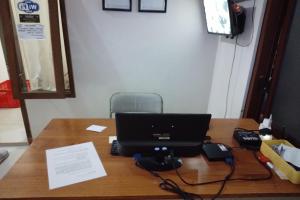 a desk with a laptop computer on top of it at Capital O 93437 Embung Banteran CottageNearLapangan Banteran in Banyumas