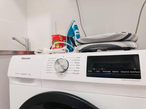 a washing machine with towels on top of it at Riverside Story Retreat at Queen Street in Brisbane