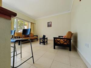 a living room with chairs and a table at Vacation Home with Lake view in Kampala