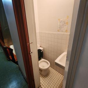 a bathroom with a toilet and a sink at New York City Guest House 2 in New York