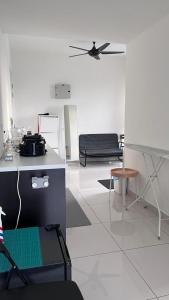 a white room with a table and a couch at Fully furnished Studio Unit. in Sungai Buluh
