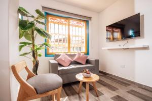 a living room with a couch and a chair at Las Palmas Apartamentos Guatapé in Guatapé