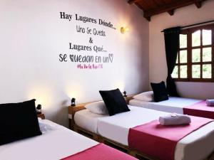 Postel nebo postele na pokoji v ubytování Casa Hostal La Vie en Rose