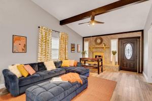 uma sala de estar com um sofá azul e uma mesa em Groovy Winter Haven Getaway - 4 bdrm near Legoland em Winter Haven