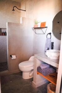 a bathroom with a toilet and a sink at Baja Temple in Todos Santos