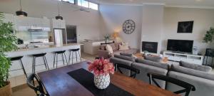 a living room with a couch and a table at Stockyards 2, Jindabyne in Jindabyne