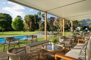 a patio with chairs and tables and a pool at Protea Hotel by Marriott George King George in George